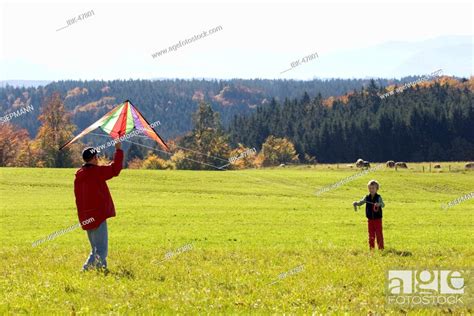 Man And Boy Flying A Kite Bavaria Germany Stock Photo Picture And