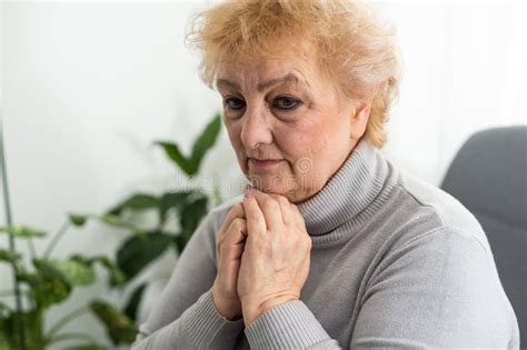 Elderly Woman Keeps Palms In Pray Gesture Closes Eyes Prays And Asks