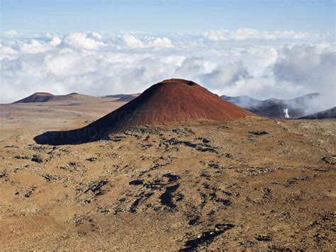 Idyllic View Of Mauna Kea Volcano Against Cloudy Sky Stock Photo