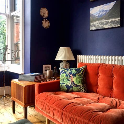 Dark Blue Walls Orange Velvet Sofa Monkey Cushions Vintage Furniture