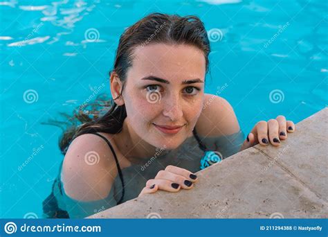 The Girl Bathes In The Pool Summer Vacation And Travel Stock Photo