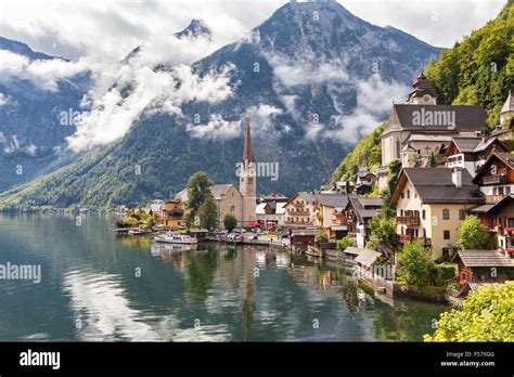 Hallstatt Village In Austrian Alps With Clouds And Mountain Lake Stock