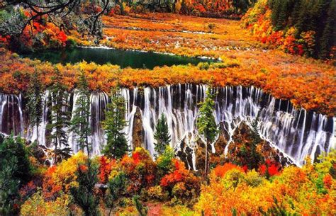An Autumn Scene With Colorful Trees And Waterfalls
