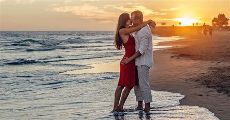 Couple Kissing On Beach During Golden Hour · Free Stock Photo