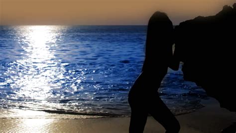 Mysterious Silhouette Sexy Girl Standing On The Beach During Sunset