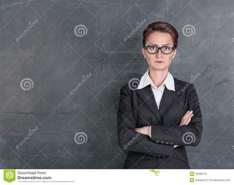 Strict Teacher In Glasses Giving Explanations While Holding Book Tutor