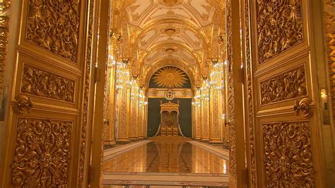 The Inside Of A Building With Gold And White Walls