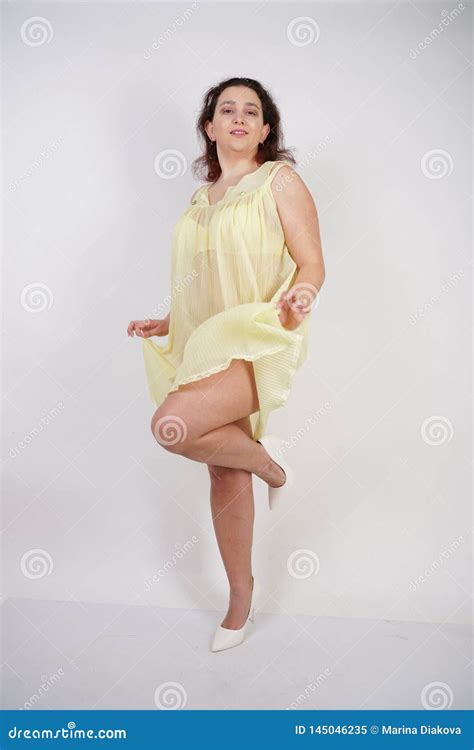 pretty chubby girl wearing fashionable yellow underwear and loves her body and herself plump