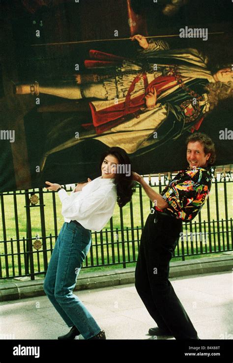 Eric Idle And Catherine Zeta Jones Carrying Painting 1993 Stock Photo