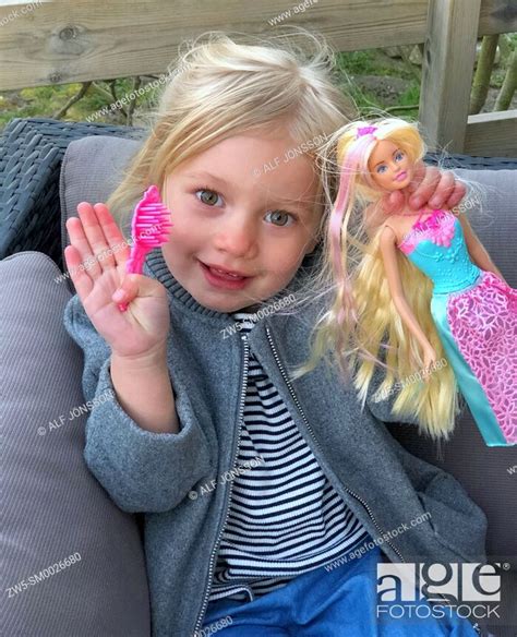 Little Girl 3 Years Old Holding A Barbie Doll Stock Photo Picture