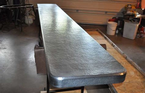 This picture is of a a guide to copper bar tops, tables and more. Hammered Zinc Countertop - Mountain Copper Creations