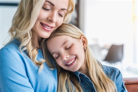 Premium Photo Portrait Of Happy Mother And Daughter Embracing With Eyes Closed At Home