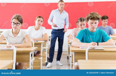Young Students Sitting At Desks In Classroom Stock Photo Image Of