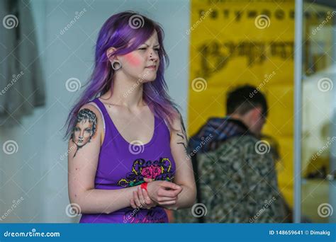 portrait of a girl with purple hair and tattoo on the shoulder fashion of the russian teenagers