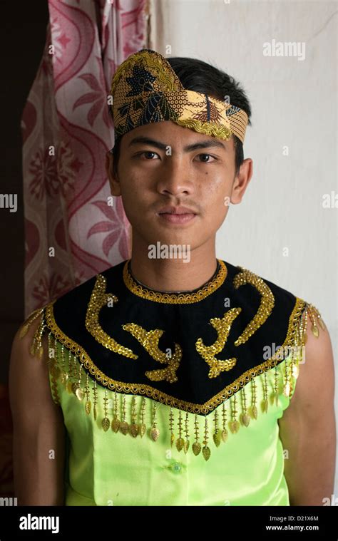 A Young Man Wearing Traditional Attire Poses Before Joining A Harvest