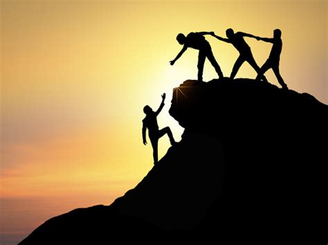 Assistance, teamwork and achievement concept. silhouette of man helping ...