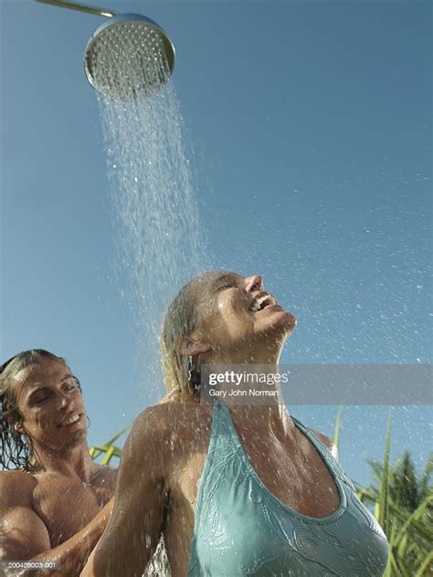 Man Rinsing Womans Hair Under Outdoor Shower Closeup Photo Getty Images