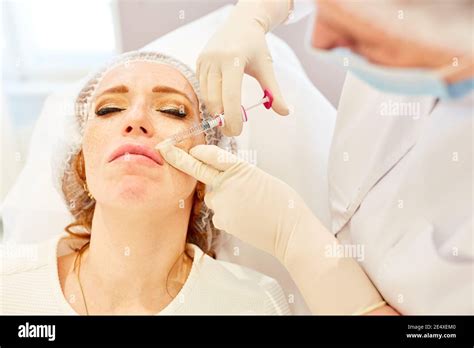 Woman Gets An Injection With Hyaluronic Acid As A Dermal Filler For Lip