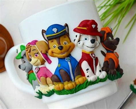 There Is A Coffee Cup Decorated With Cartoon Characters