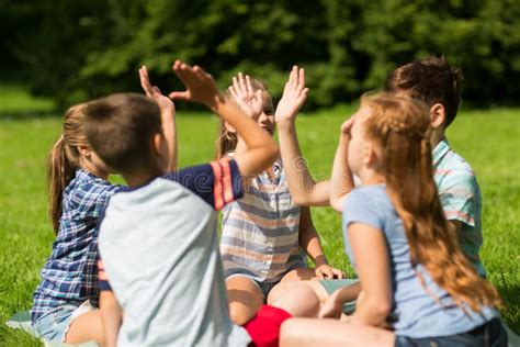 Group Of Happy Kids Making High Five Outdoors Stock Photo Image Of