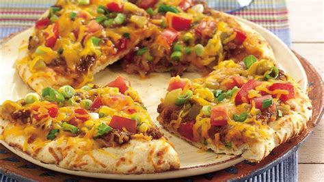Not just your average nachos. Easy Grilled Nacho Pizzas Recipe - Tablespoon.com