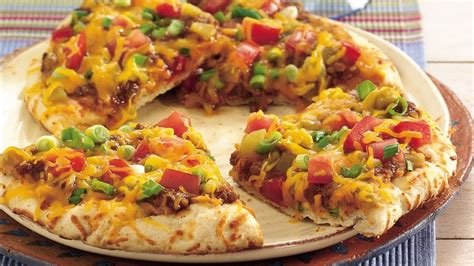 In a small bowl, whisk together the olive oil, oregano, garlic powder and crushed red pepper. Easy Grilled Nacho Pizzas Recipe - Tablespoon.com