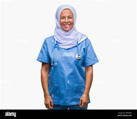 middle age senior arab nurse woman wearing hijab over isolated background with a happy and cool