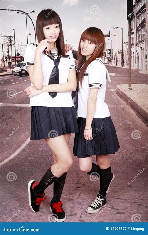 Two Attractive Schoolgirls In The Bed Stock Image