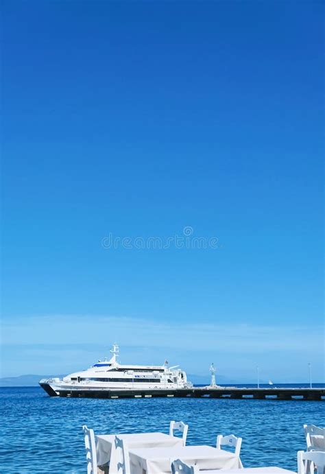 Empty Restaurant By The Aegean Sea And Cruise Boat Editorial Image