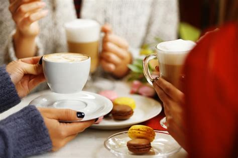 Premium Photo Women Meeting In Cafe And Drinking Latte