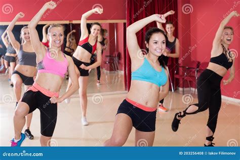 Group Of Positive Active Girls Training Zumba Stock Photo Image Of Performing Aerobics