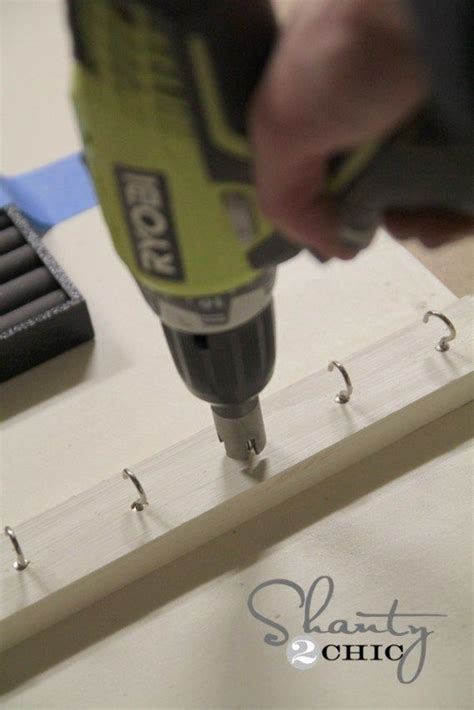 A Drill Is Being Used To Attach Screws On A Piece Of Wood