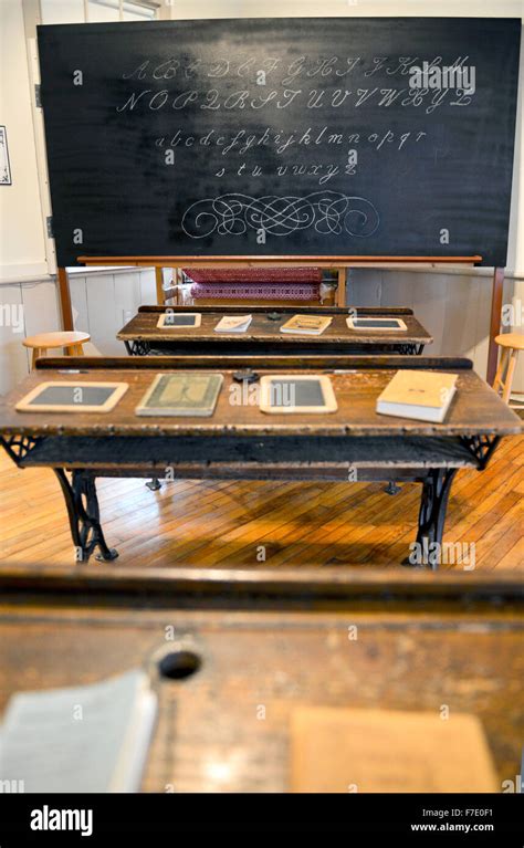 Old One Room Schoolhouse Interior With Desks And Blackboard Stock Photo