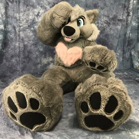 A Stuffed Animal With A Heart On Its Chest And Paw Prints In The Shape