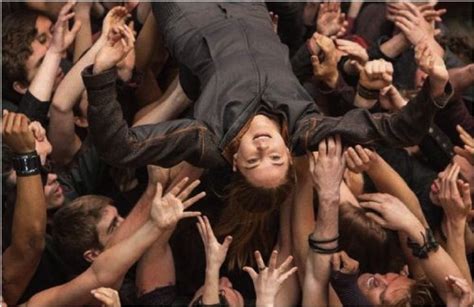 Other Dauntless Members Lift Tris Into The Air During Initiation