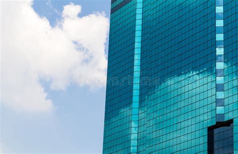 High Rise Glass Building With Sky And Clouds Reflection Stock Photo