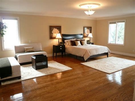 The room features hardwood floors and rustic walls, along with a wooden ceiling with wooden beams. Best Bedroom Flooring Ideas