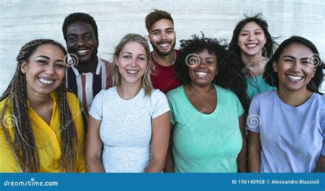 Group Of Multiracial Friends Sitting On A Tble Outdoor Using Smartphones Royalty Free Stock