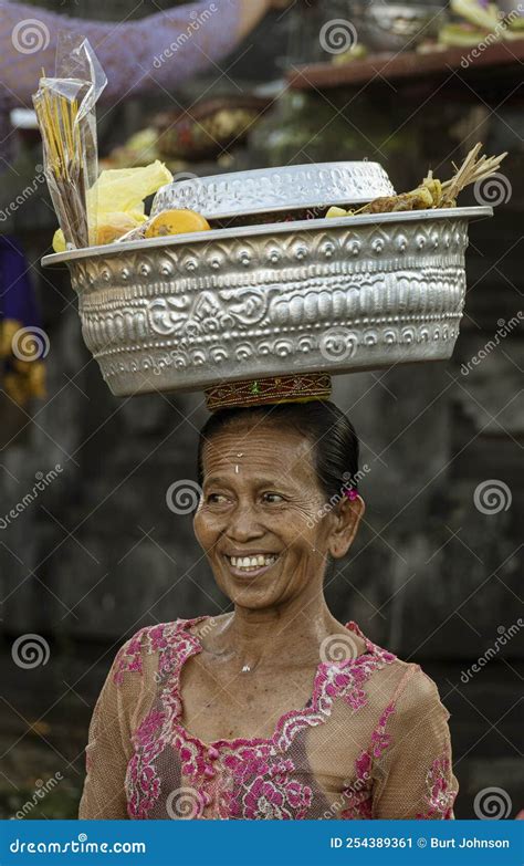 bali indonesia june 1 2022 woman carries basket on her head as she walks editorial photo