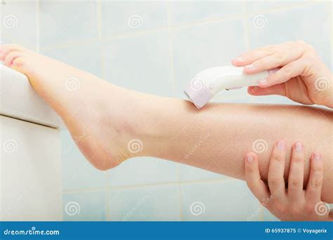 Woman Shaving Legs With Depilator In Bathroom Stock Image Image Of Treatment Female