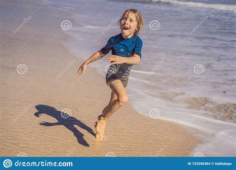 Cute Little Boy Having Fun On Tropical Beach During Summer Vacation