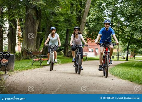 Healthy Lifestyle Happy People Riding Bicycles In City Park Stock