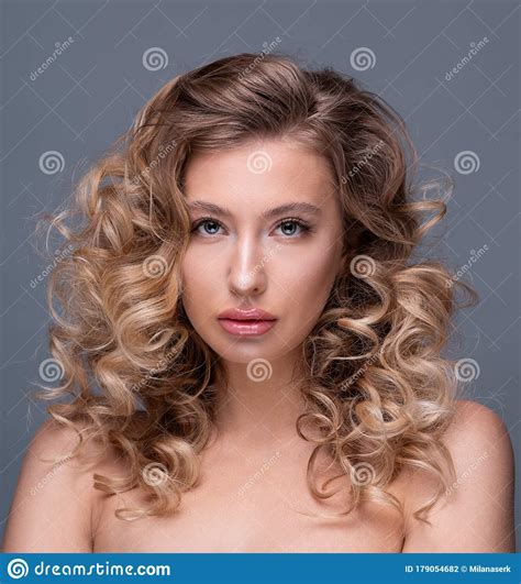 Beautiful Girl With Curly Blond Hair And Flawless Skin Stock Photo