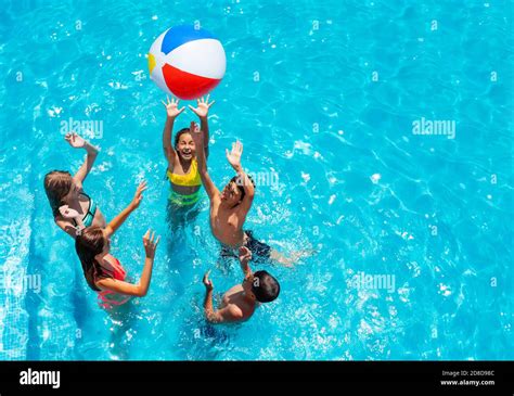 Group Of Kids In Swimming Pool Play With Inflatable Ball View From