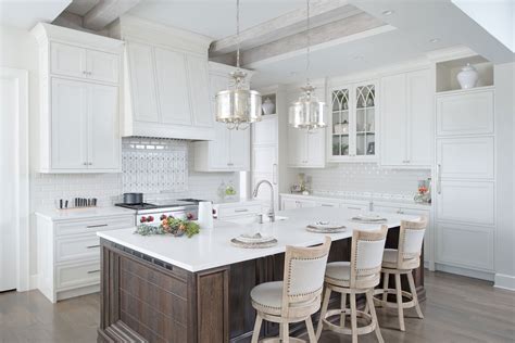 This island cart is perfect for those looking to add extra workspace in their kitchen. Painted White Kitchen with Dark Wood Island - Crystal Cabinets