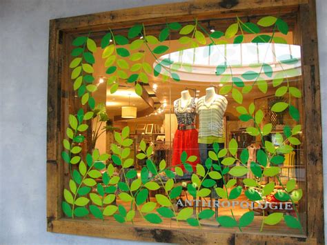A Store Window With Green Leaves On It
