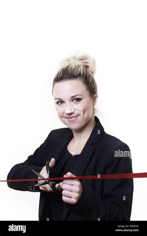 Woman Standing Cutting Ribbon With A Pair Of Scissors Stock Photo Alamy