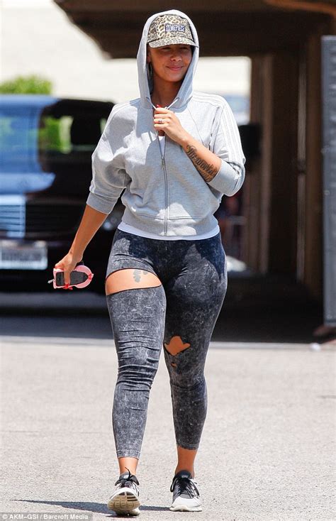 Amber Rose Adds Provocative Touch To Dull Leggings By Slashing Them At