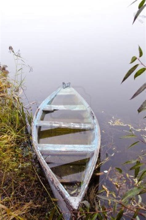 Mystical Wooden Boat On Foggy River