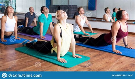 Adults Having Yoga Class In Sport Club Stock Photo Image Of Happy
